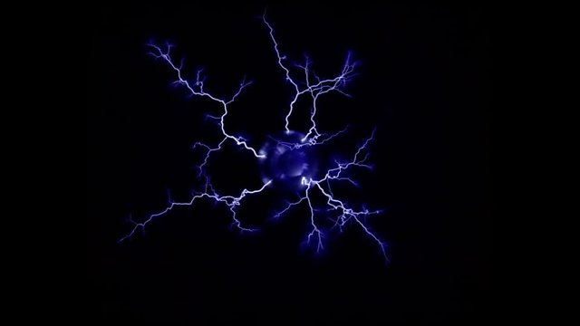 Overhead view of multiple blue electric arcs emanating from Tesla coil