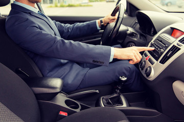 close up of young man in suit driving car