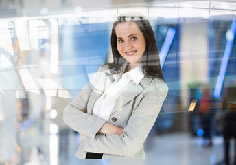 Attractive woman portrait in the office with people at the background
