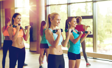 group of women with dumbbells in gym