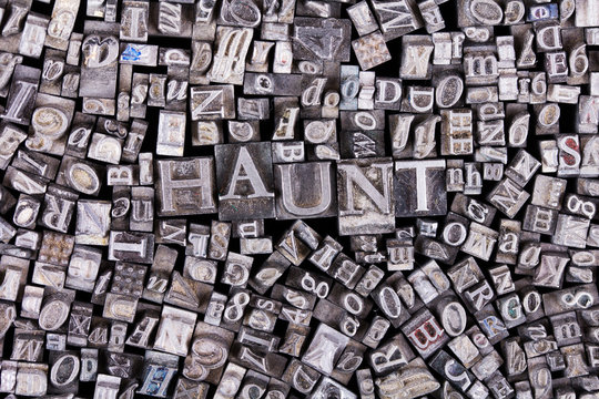 Close up of typeset letters with the word haunt