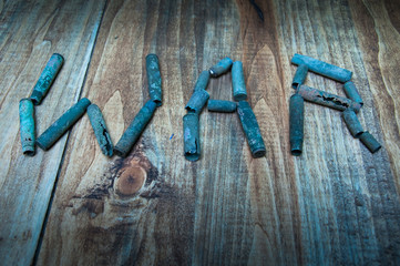 WAR made with cartridge shells on wooden table