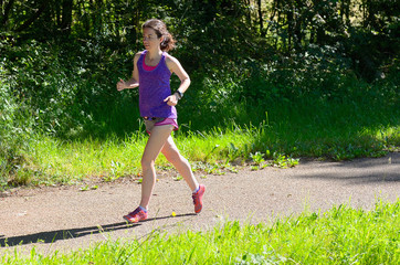 Active woman runner jogging in park, outdoors running, sport and healthy lifestyle concept
