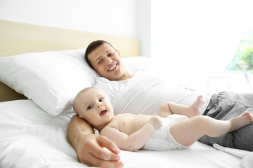 Fototapeta na wymiar Father with son lying on bed