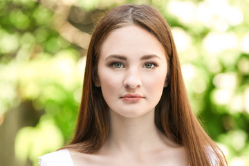Fototapeta premium Portrait of beautiful girl on blurred nature background