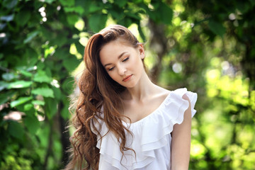 Fototapeta premium Beautiful girl relaxing in green park