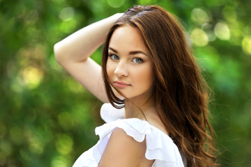Naklejka premium Beautiful girl relaxing in green park