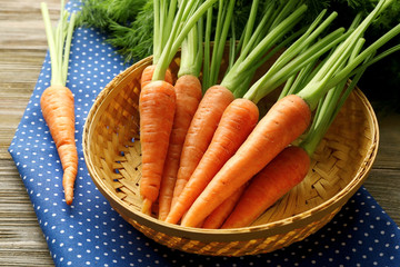 Carrots in wicker bowl, closeup