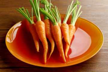 Carrots on orange plate