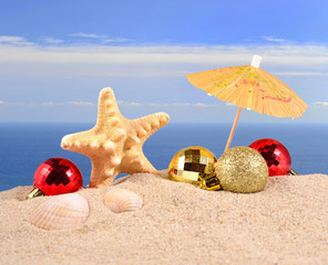 Fototapeta na wymiar Christmas decorations seashells and starfish on a beach sand