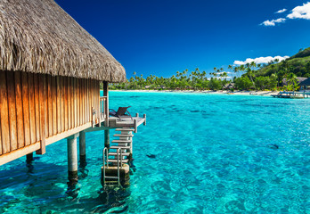 Water villas on the green tropical reef