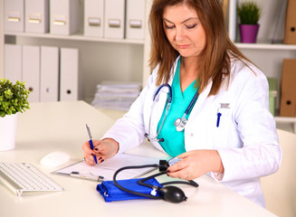 Portrait of happy medical doctor woman in office