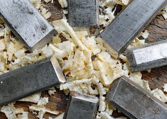 series of many sharp steel blades many chisels and sawdust chipp