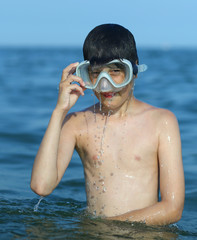 child has fun with the diver mask in the sea © ChiccoDodiFC
