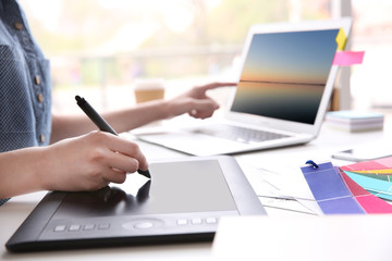 Woman using graphic tablet at office
