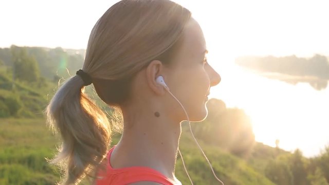 Healthy Active Lifestyle. Young Attractive Jogger Woman Listening to Music.
