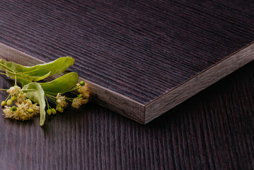 Dark laminated chipboard with linden flowers