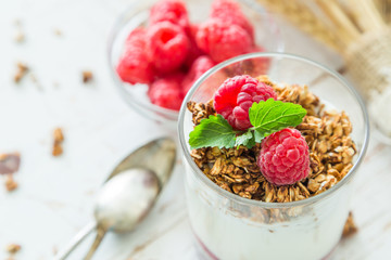Granola with rasberry and yogurt in glass
