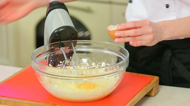 Cheff is crushing eggs and making dough