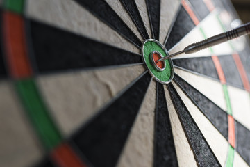 Single dart hitting bull's eye on the dartboard