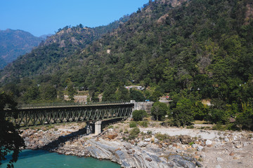 Naklejka premium Bridge over the Ganga, walking around Rishikesh, holy Indian pla