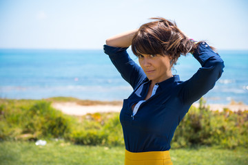 Fototapeta premium Beautiful woman posing in a park in from the beach