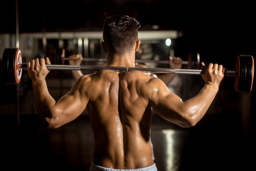 Fototapeta na wymiar muscular man training in gym