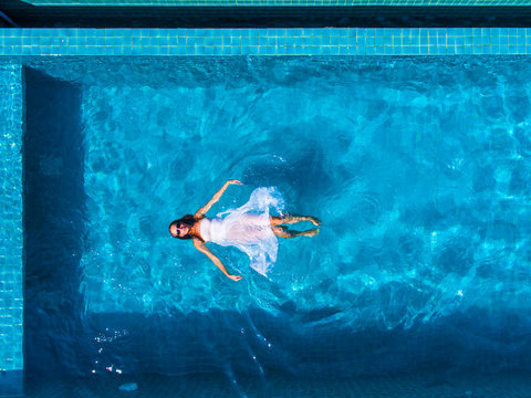 Model In swimming pool aerial view