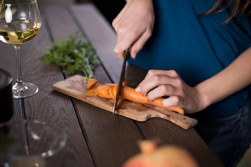 Woman cutting carrots