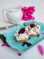 Breakfast of sandwiches with cheese and jam from blueberries.