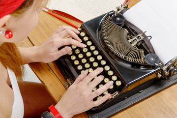 hands of a young woman with an old typewriter