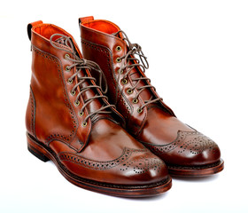 Wingtip dark chili dress boots isolated on white