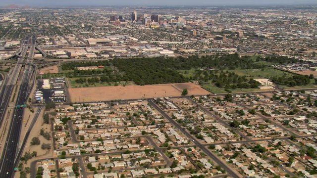 Wide approach toward distant downtown Phoenix from outlying areas. Shot in 2008.