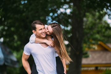 Young adult brunette man and woman in the park