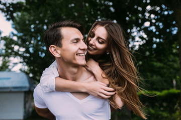 Fototapeta premium Young adult brunette man and woman in the park