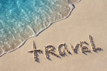 Travel Word Handwritten on Sandy Beach