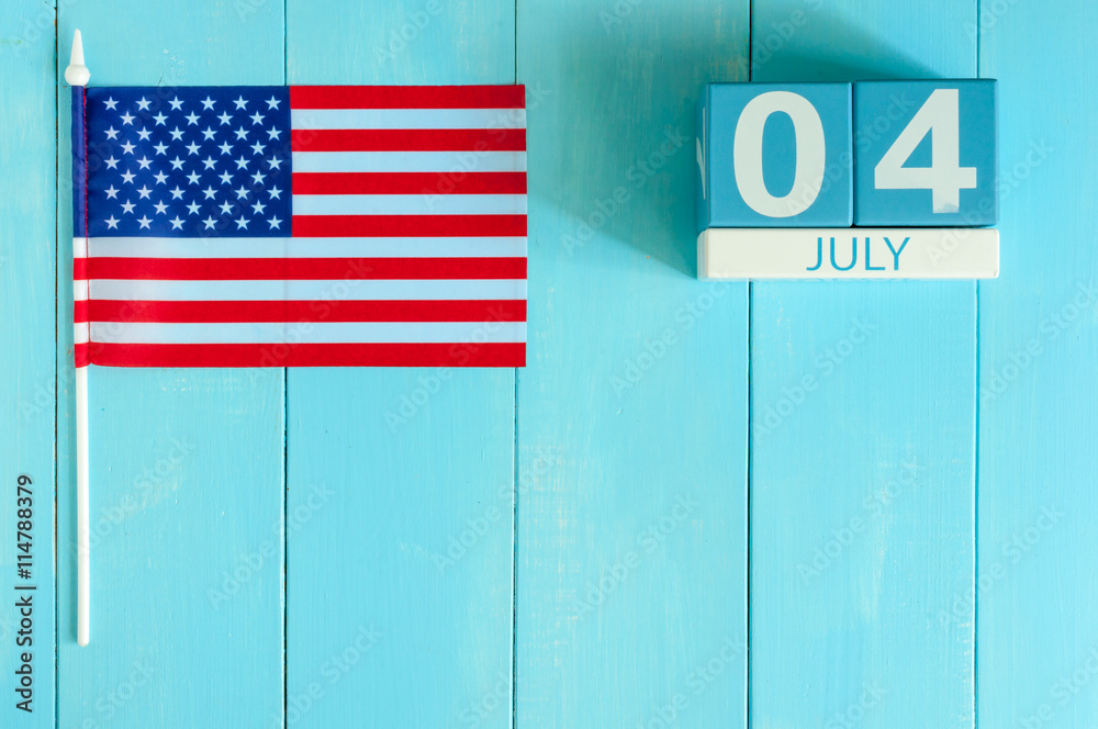 Wall mural july 4th wooden color calendar with stars and stripes flag on blue background with flag of the usa. 