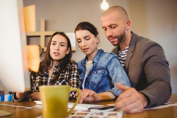 Team of graphic designer working on computer