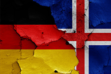 flags of Germany and Iceland painted on cracked wall
