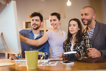 Team of graphic designers working on a computer