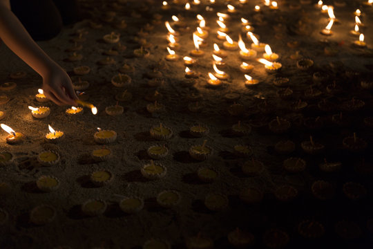 People light candle to pay respect to buddha relic