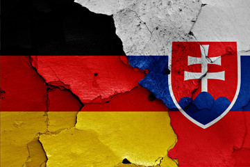 flags of Germany and Slovakia painted on cracked wall
