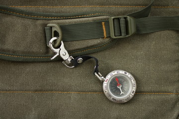 Naklejka premium Compass with safety hook on the strap of a backpack
