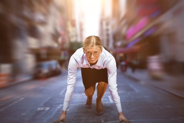 Composite image of business woman in the starting blocks