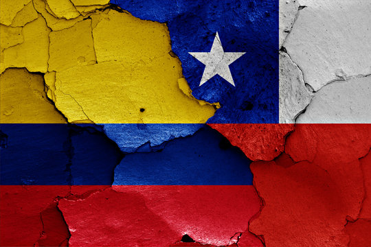 flags of Colombia and Chile painted on cracked wall