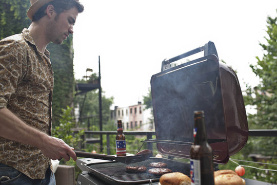 Young man barbecuing