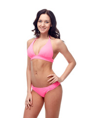 Obraz premium happy young woman in pink bikini swimsuit