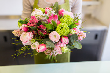 close up of woman holding bunch at flower shop