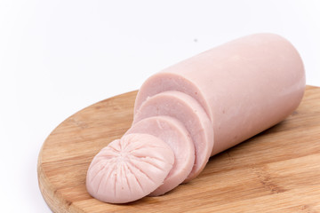 Bologna salami sliced on the wooden board, isolated on white bac