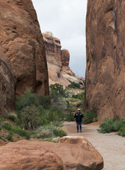 Hiker at Devils Garden Trailhead at Arches National Park in Moab Utah.